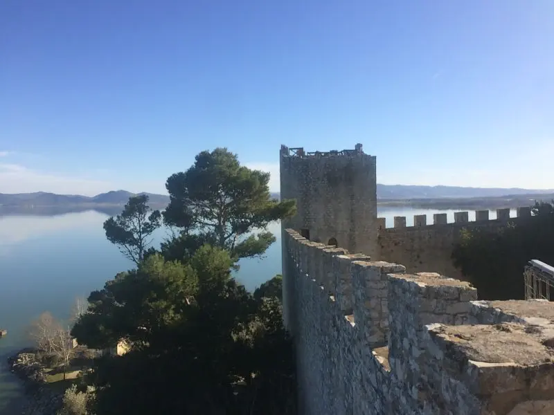 One Of The Castle Towers With Lake Trasimeno In The Background, Rocca Del Leone